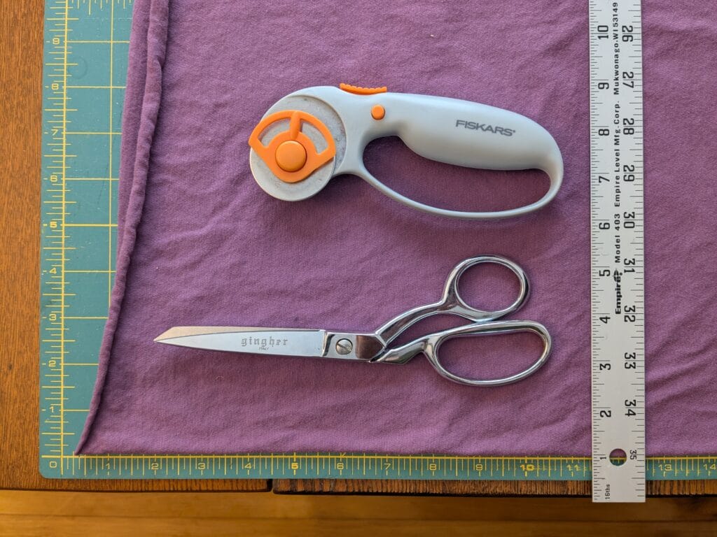 a picture of supplies needed for DIY hankies - fabric, cutting mat, ruler, scissors, rotary cutter