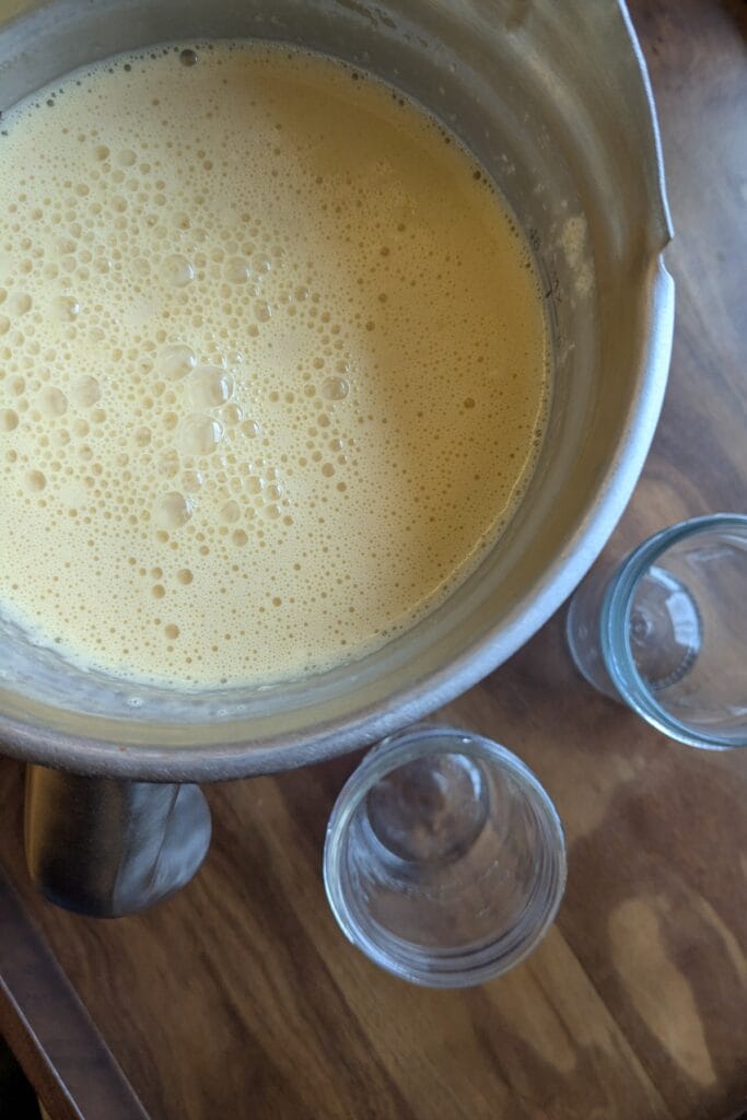 A blender full of orange Julius ready to be drunk or turned into popsicles.