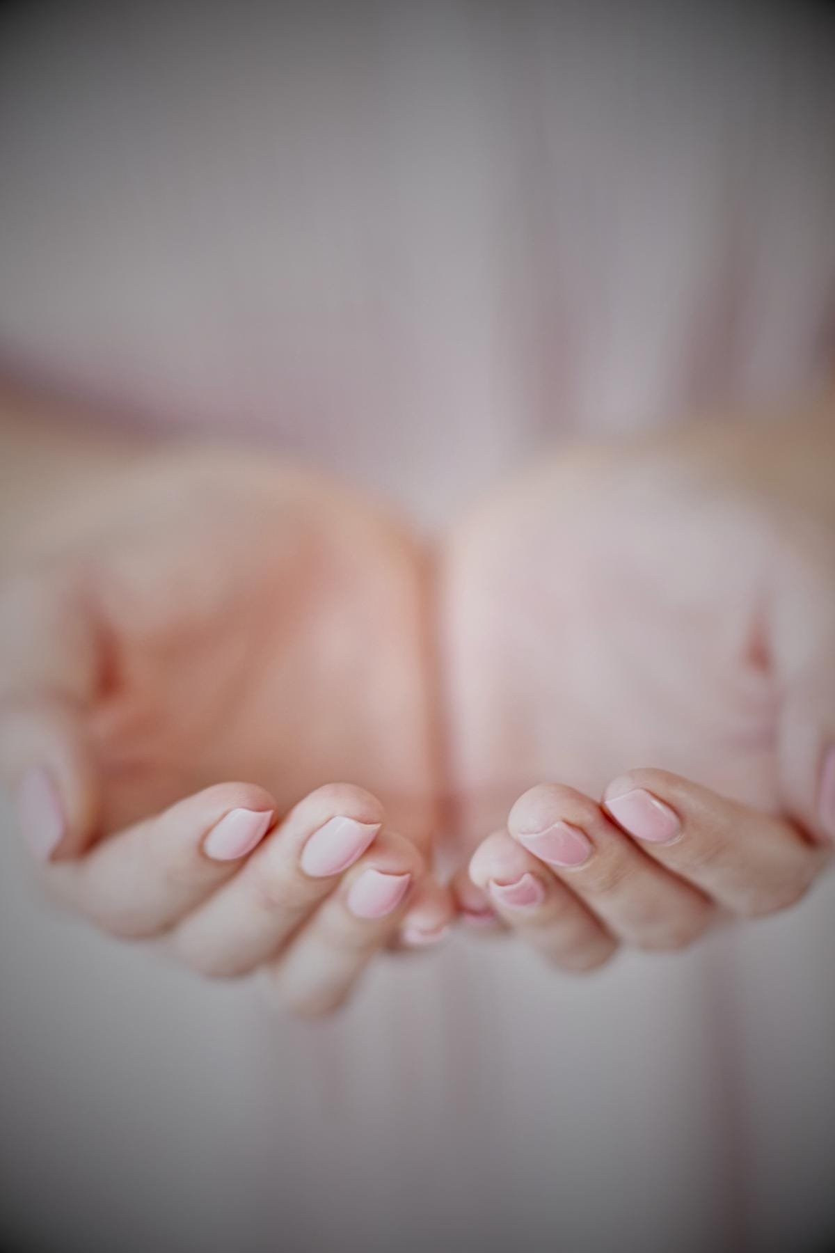 a woman placing her hands together in front of her as if she is holding something, but they are empty. This represent a baby she longed for but she will never hold because of pregnancy loss.