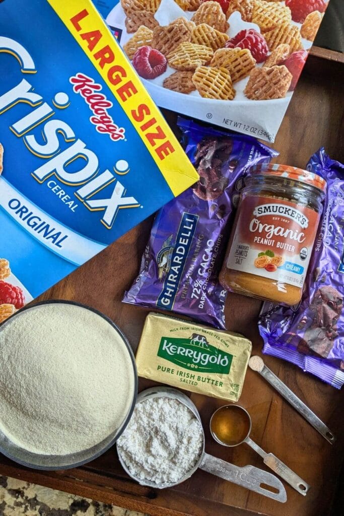 ingredients for high protein puppy chow: cereal (Crispix), organic natural peanut butter, pastured Kerrygold butter, pastured collagen peptides, Himalayan sea salt, homemade vanilla extract, and organic powdered sugar.