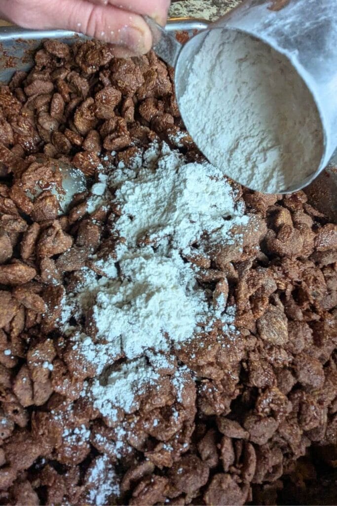 mixing powdered sugar into puppy chow, but 3/4 of the called for amount was replaced with collagen peptides to make this puppy chow recipe with more protein and less sugar