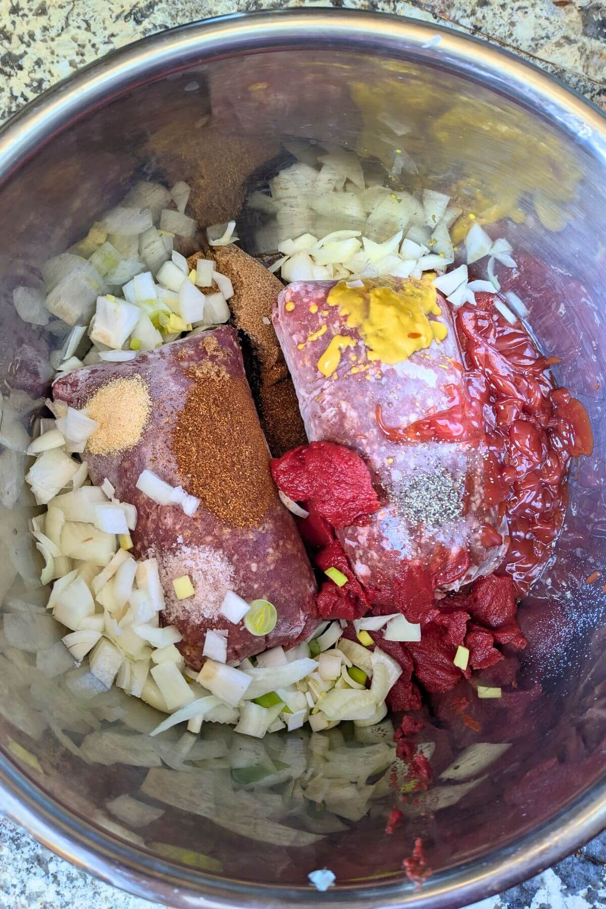 frozen ground beef, onion and seasonings for loose meat tavern sandwich recipe in an InstantPot