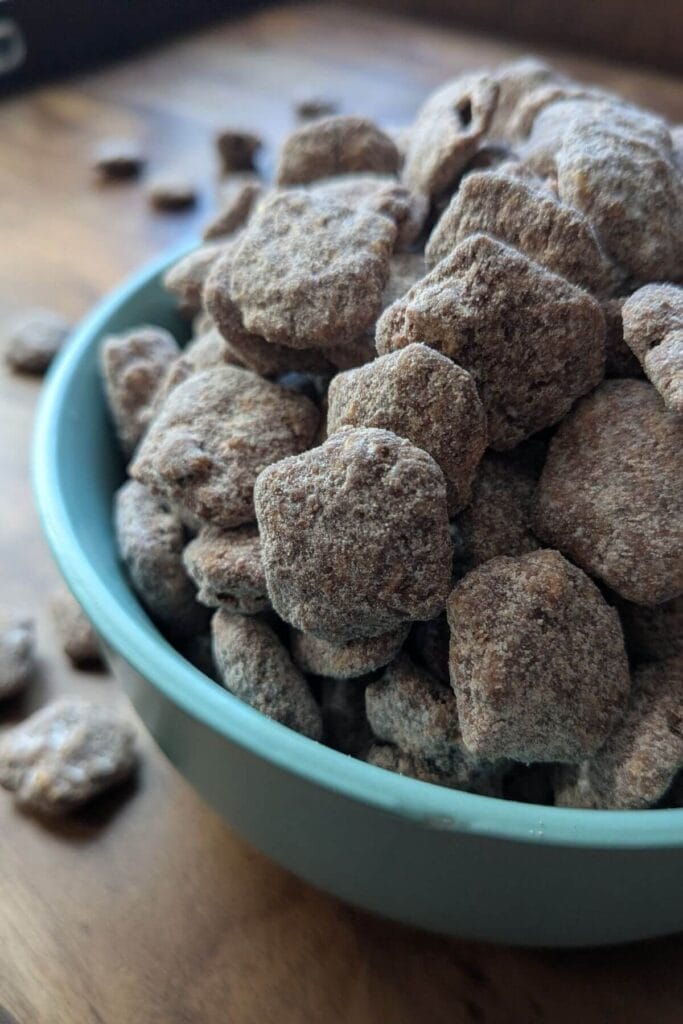 High protein puppy chow recipe with dark chocolate and a collagen peptides and powdered sugar coating