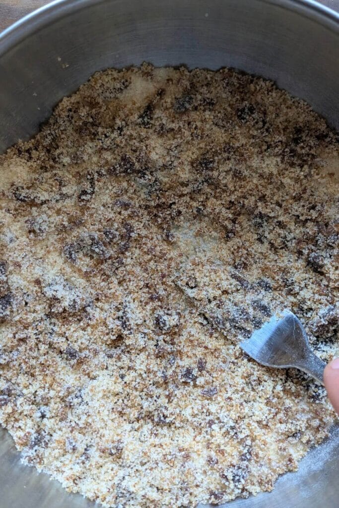 Granulated sugar and molasses being mixed together.