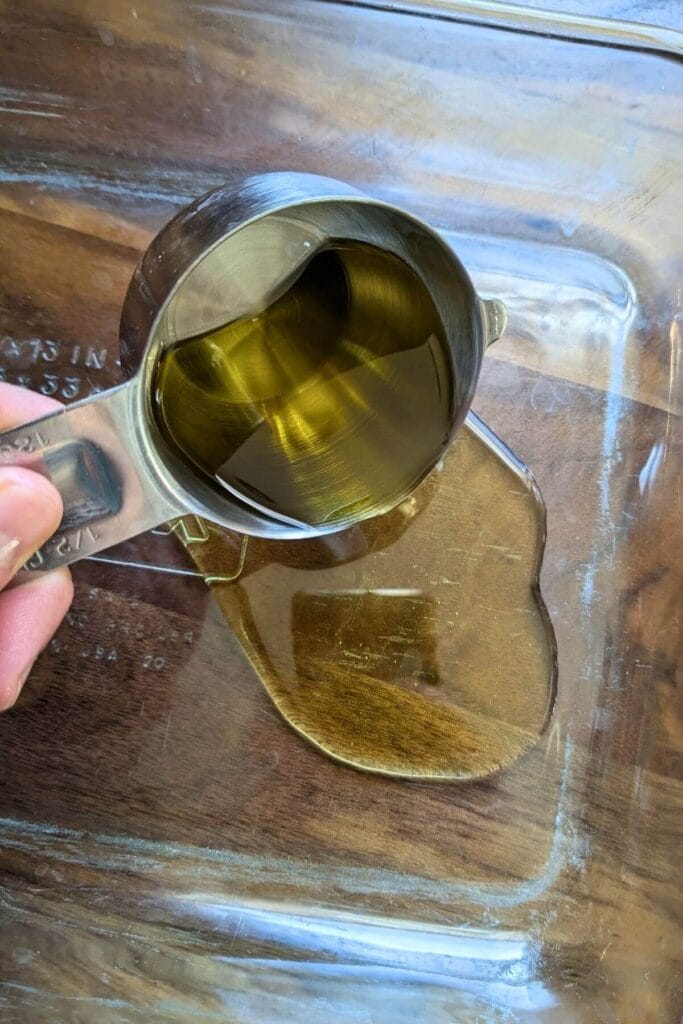 Pour half of the olive oil in the baking pan for the dough's only rise.