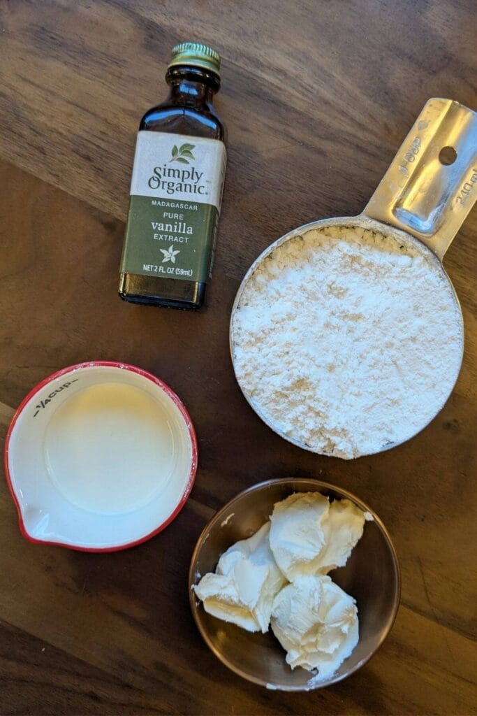 ingredients for cream cheese frosting: powdered sugar, cream cheese, milk, vanilla