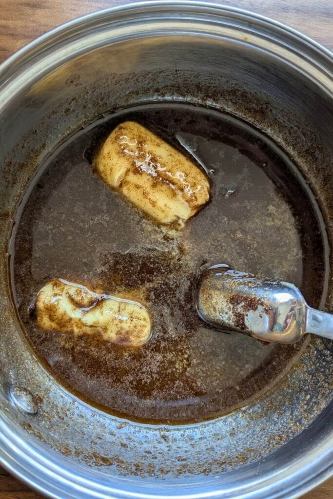 melt the butter, brown sugar, cinnamon and vanilla in a saucepan for the topping of this cinnamon roll focaccia bread