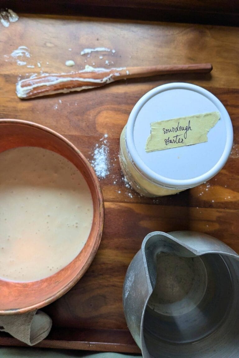a tray full of everything you need to make Sourdough Starter and a quart sized mason jar with a white lid that says "sourdough starter"