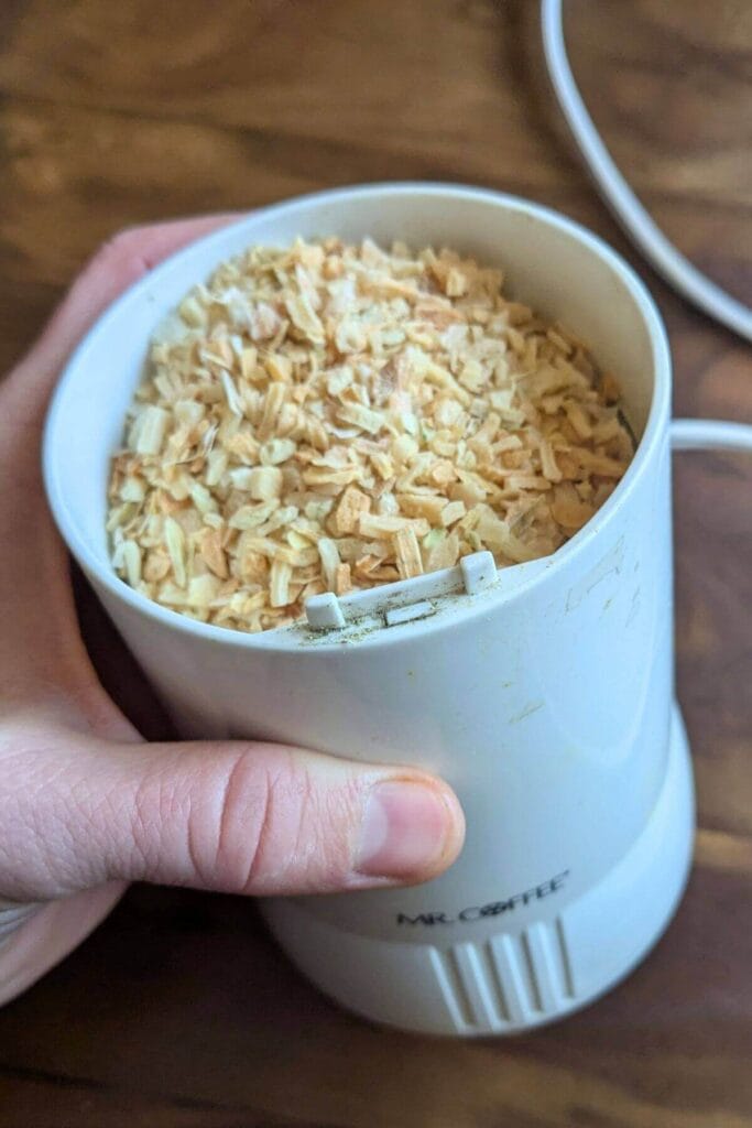 chopped dried onions in a coffee grinder