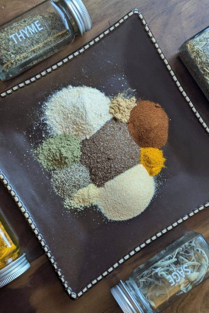 Ingredients for homemade chophouse seasoning including smoked salt, garlic, herbs and spices